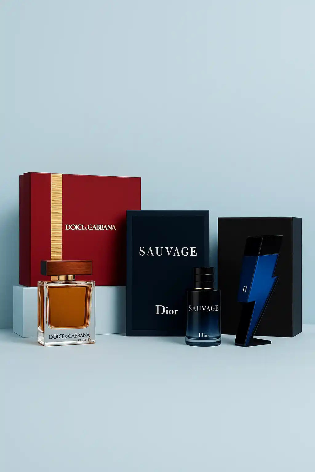 Dolce & Gabbana and Dior perfume bottles with packaging on a light blue background